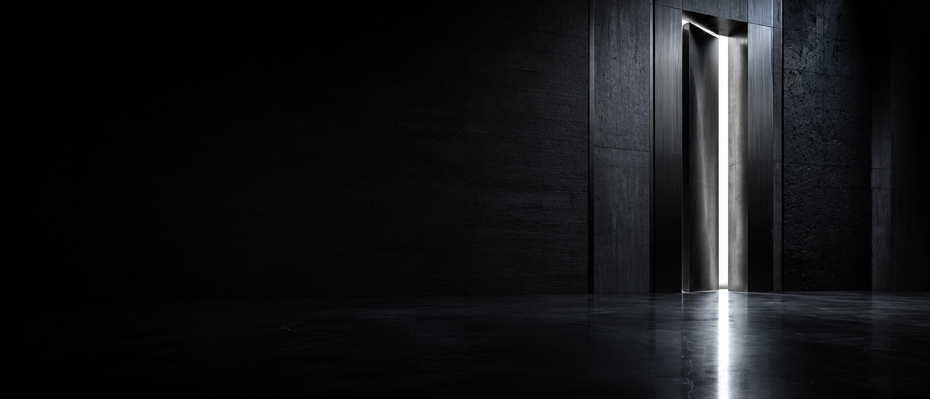 A monumental black stone wall with a geometric portal emitting a vertical blade of light